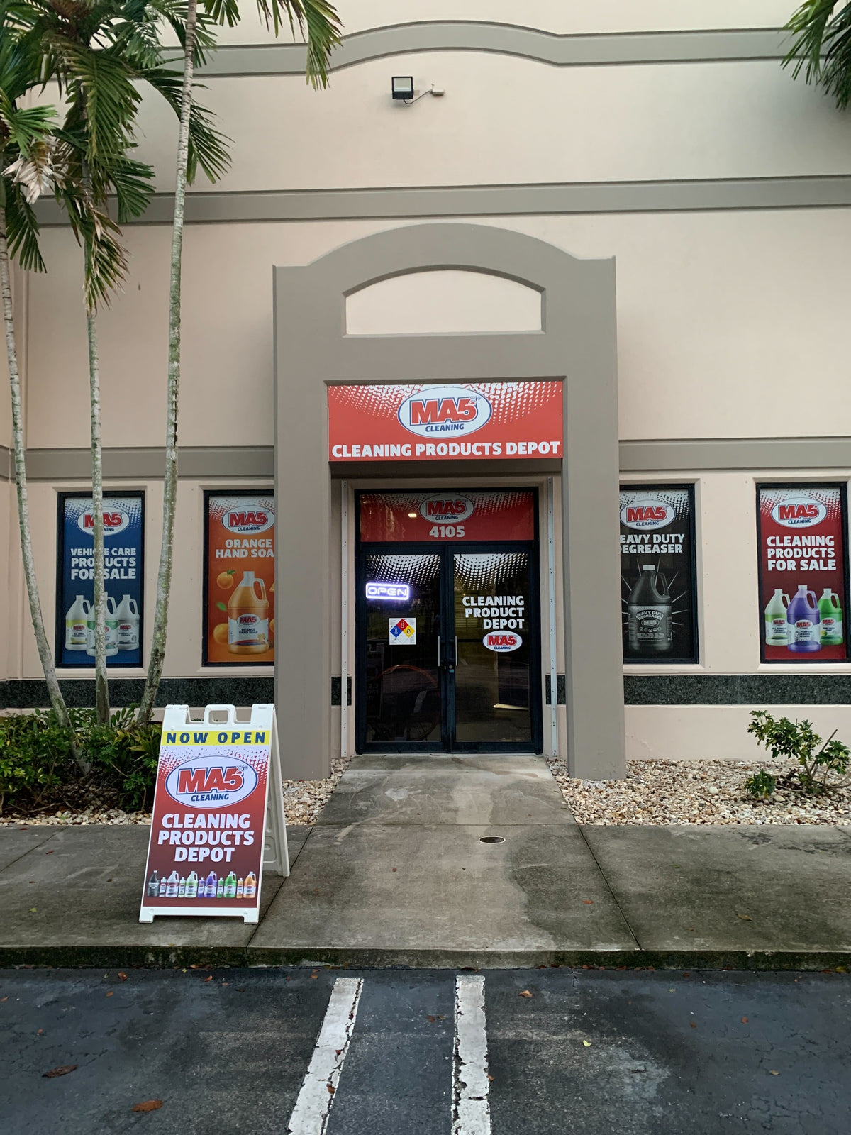 MA5x Cleaning Products Store entrance with promotional signs outside.