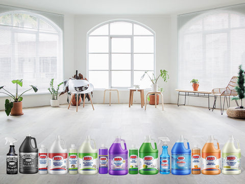Row of MA5x cleaning products displayed in a living room with large windows.