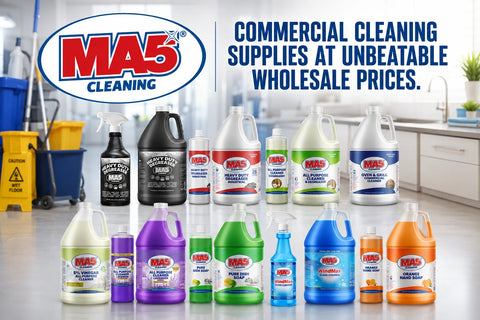 A collection of MA5X Cleaning commercial supplies, including various bleach and disinfectant bottles in different colors, displayed in front of a bright commercial kitchen background. The image features the MA5X Cleaning logo on the top left and promotional text on the top right.